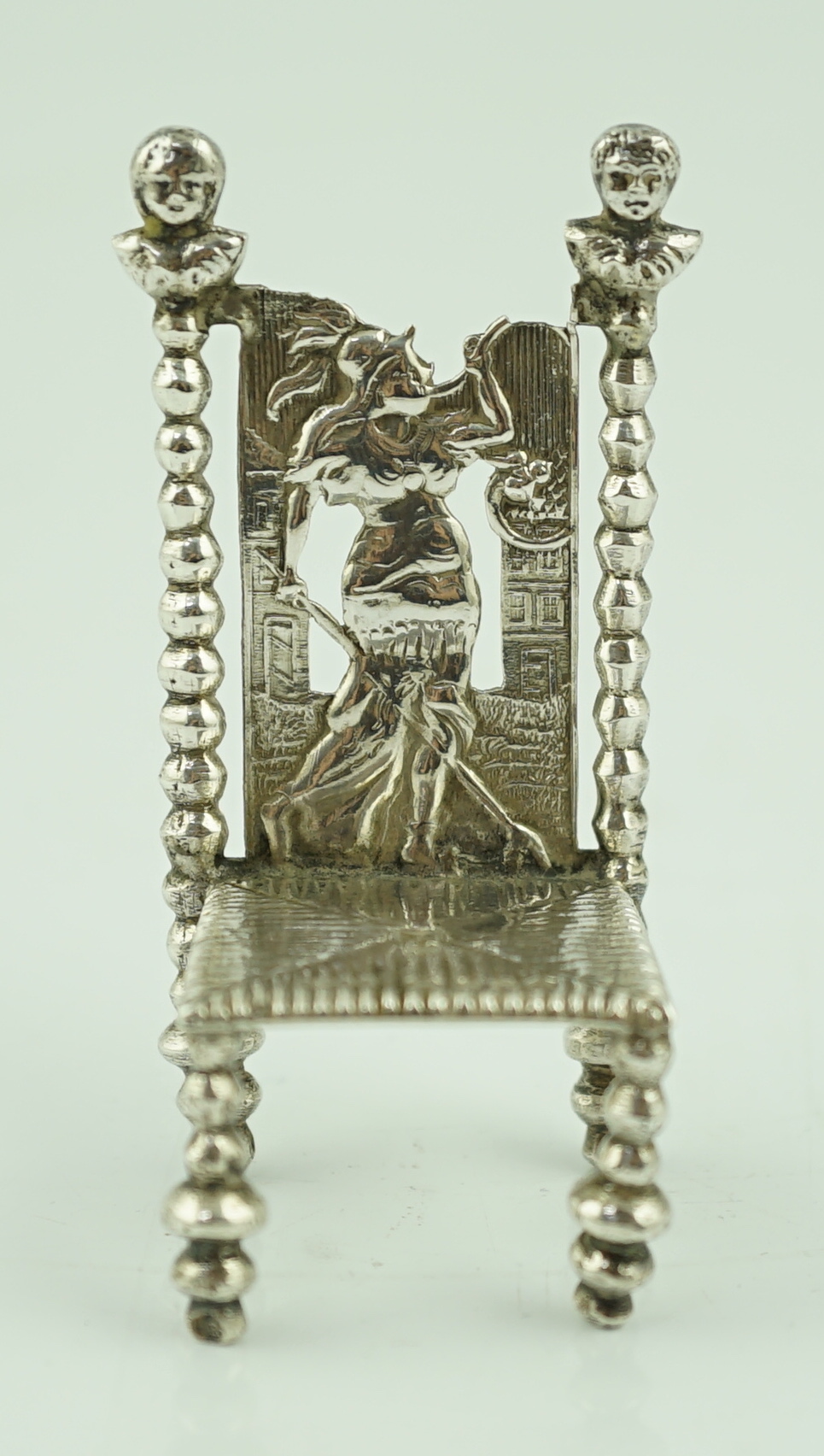 A late 19th century Dutch silver miniature model of a high back chair, import marks for B.H. Joseph & Co